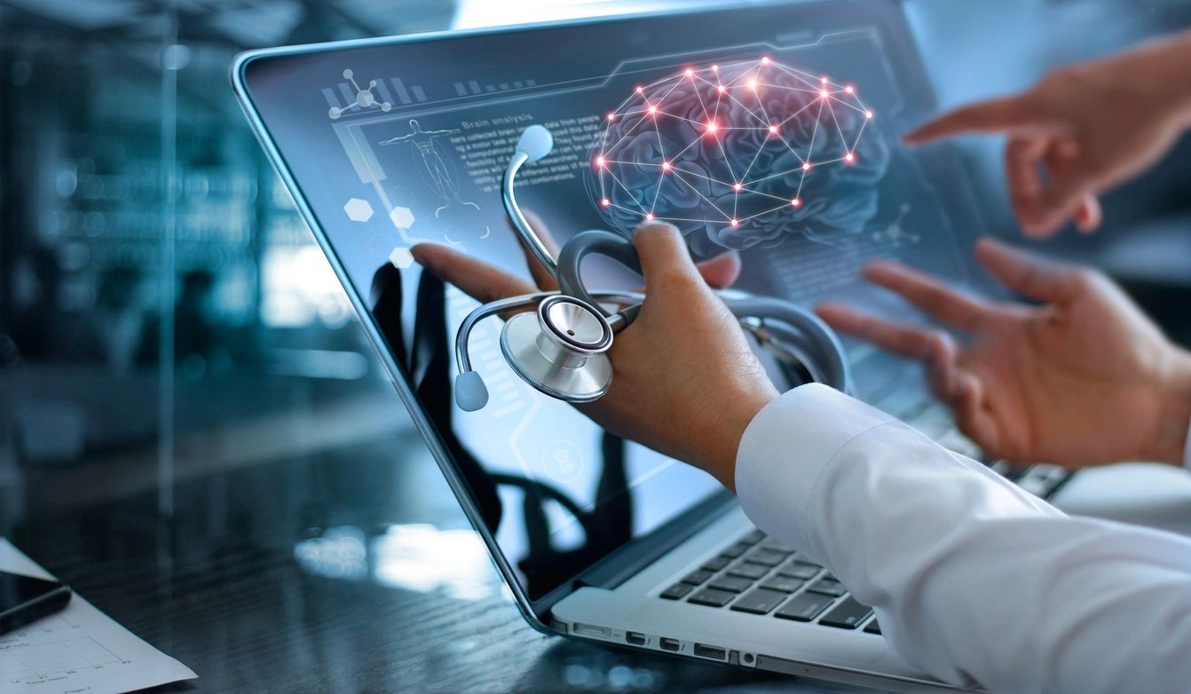 Doctor using laptop with digital brain hologram.